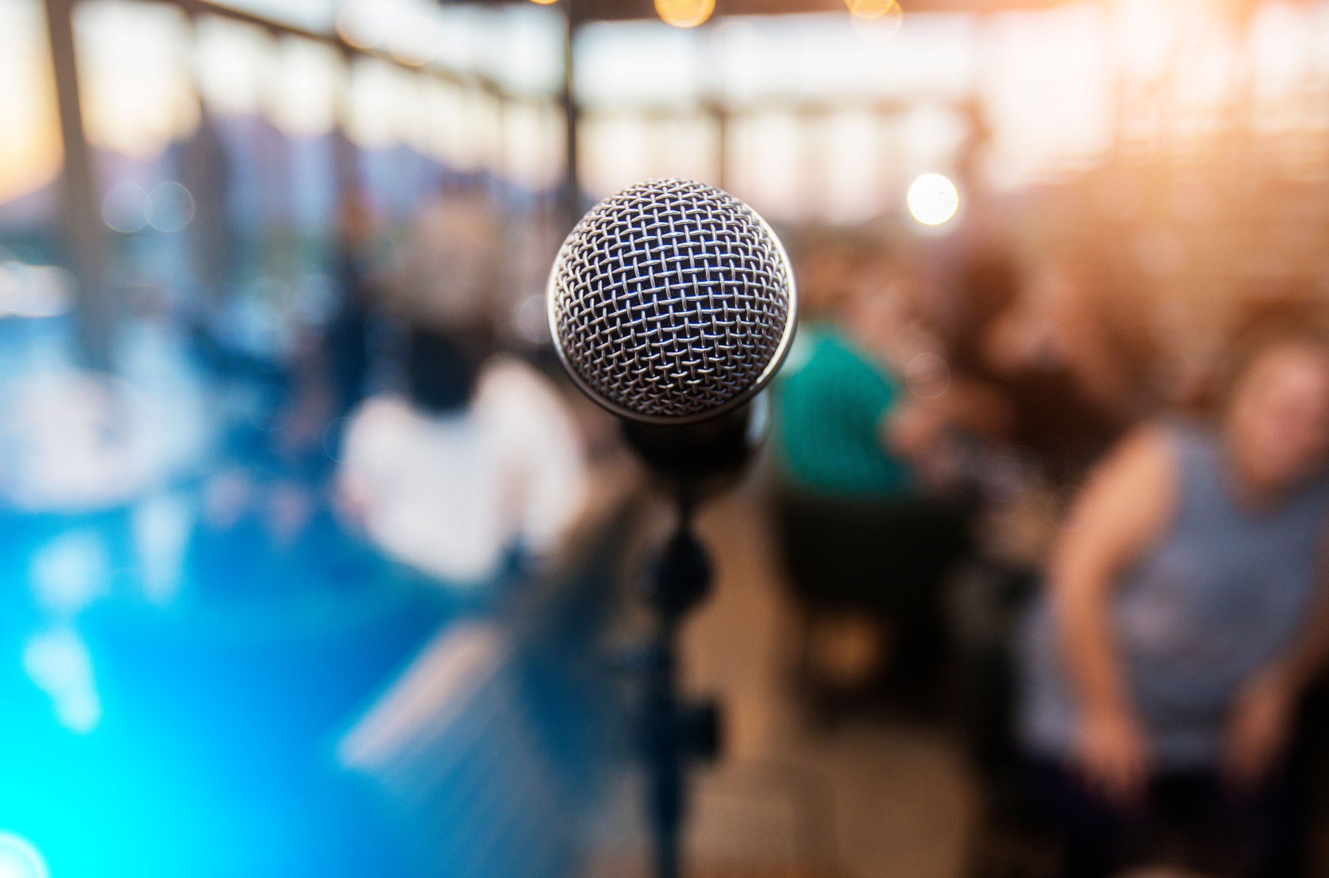 Microphone infront of an out of focus audience
